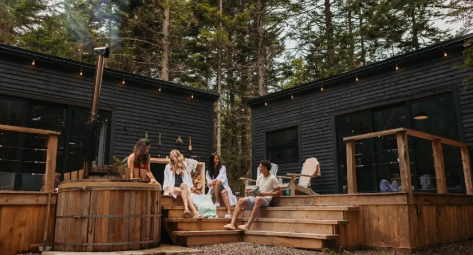 people talking in front of cabin