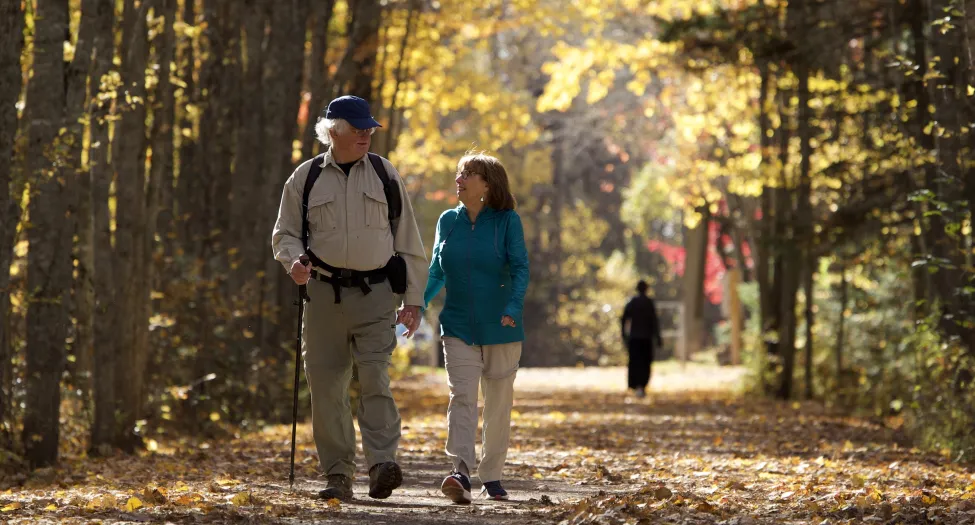 Senior couple walking a trail in the Fall