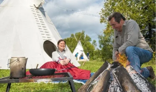 two people by a camp fire